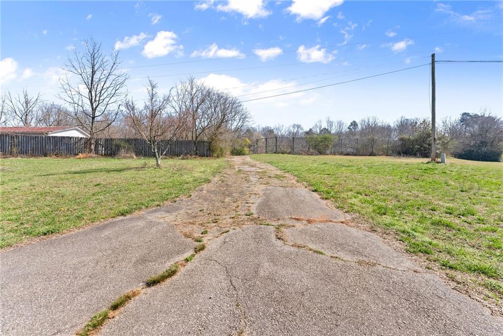 111 Skitts Mountain Road Cleveland, GA 30528 - Photo 28 of 60 a view of a field of grass and a building