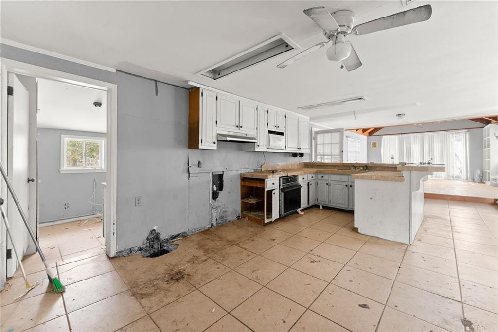 111 Skitts Mountain Road Cleveland, GA 30528 - Photo 41 of 60 a kitchen with a stove a sink and a refrigerator