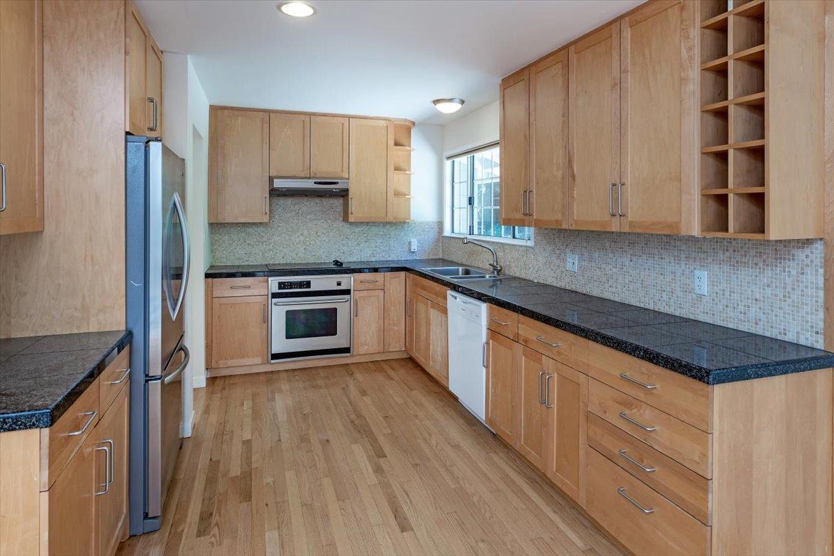21685 Woolaroc Drive Los Gatos, CA 95033 - Photo 11 of 28 a kitchen with granite countertop wooden cabinets a sink and stainless steel appliances