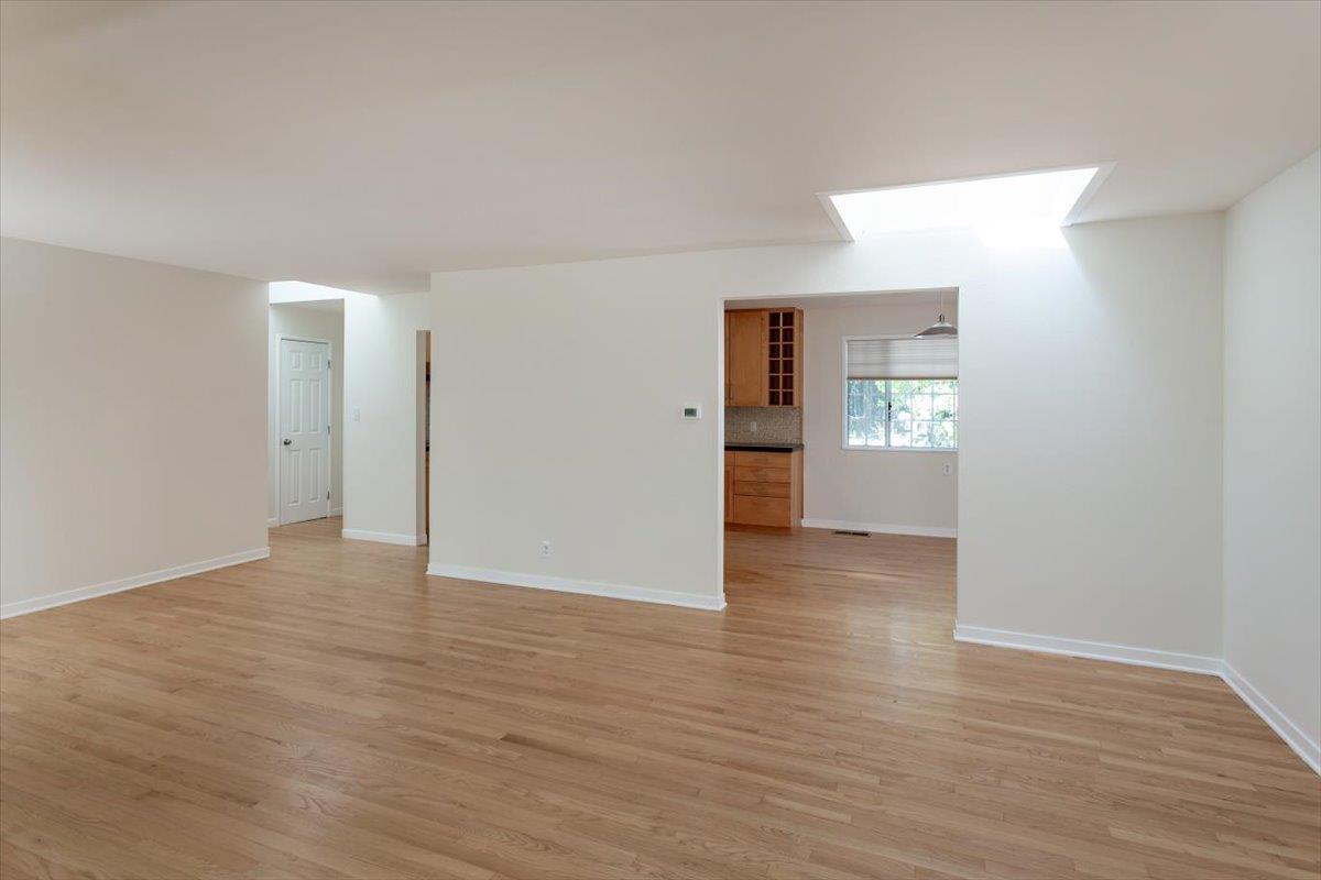 21685 Woolaroc Drive Los Gatos, CA 95033 - Photo 10 of 28 a view of empty room with wooden floor and cabinet
