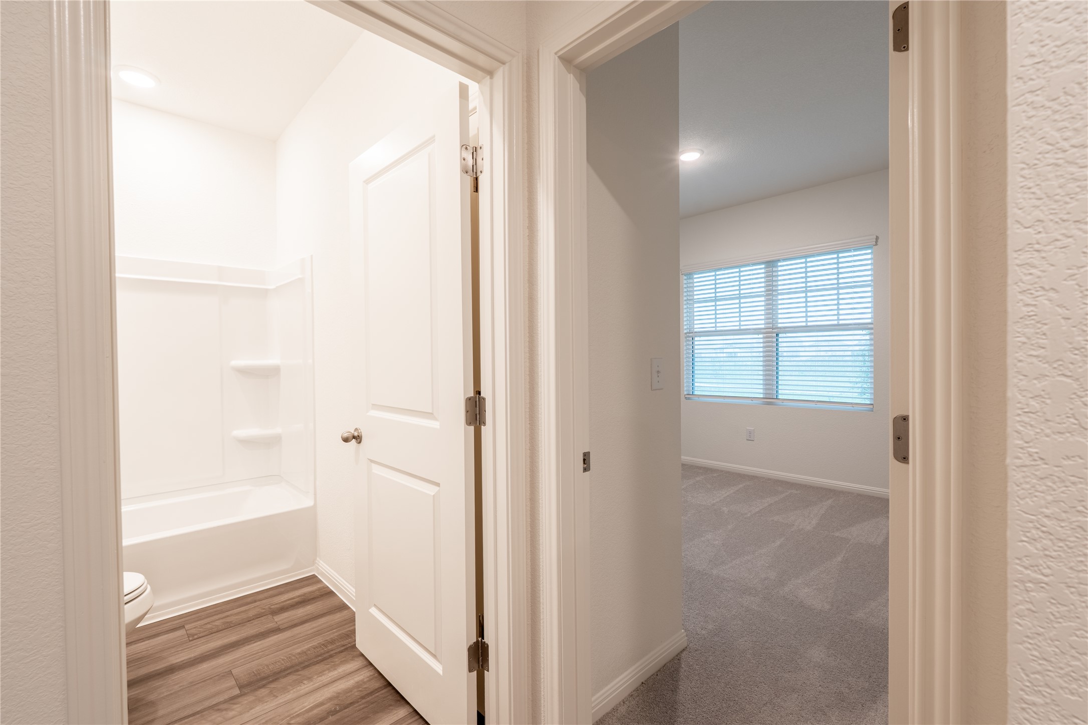 144 Mullen Way Taylor, TX 76574 - Photo 14 of 26 a view of a hallway with wooden floor and closet