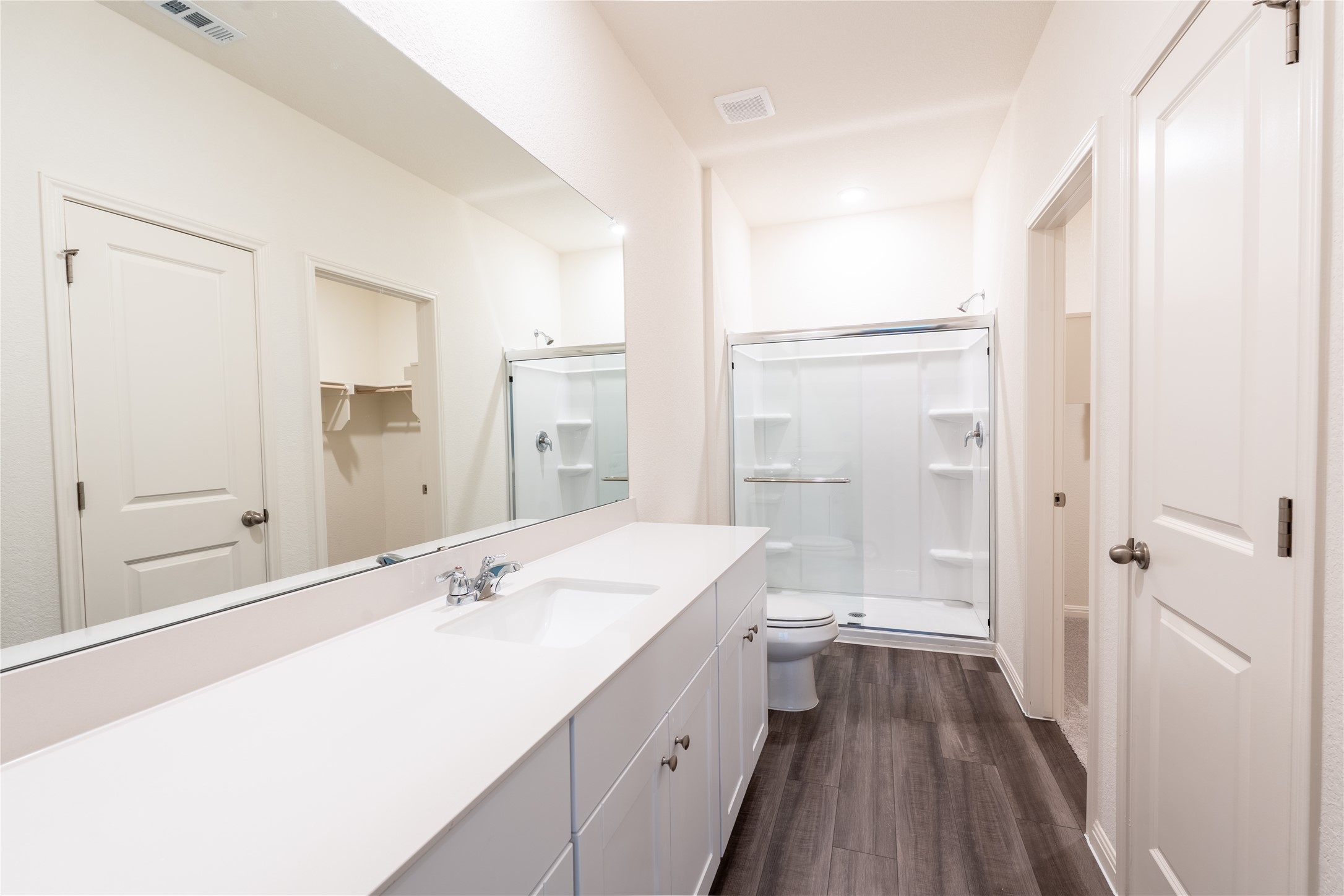 144 Mullen Way Taylor, TX 76574 - Photo 22 of 26 a spacious bathroom with a shower sink and a mirror