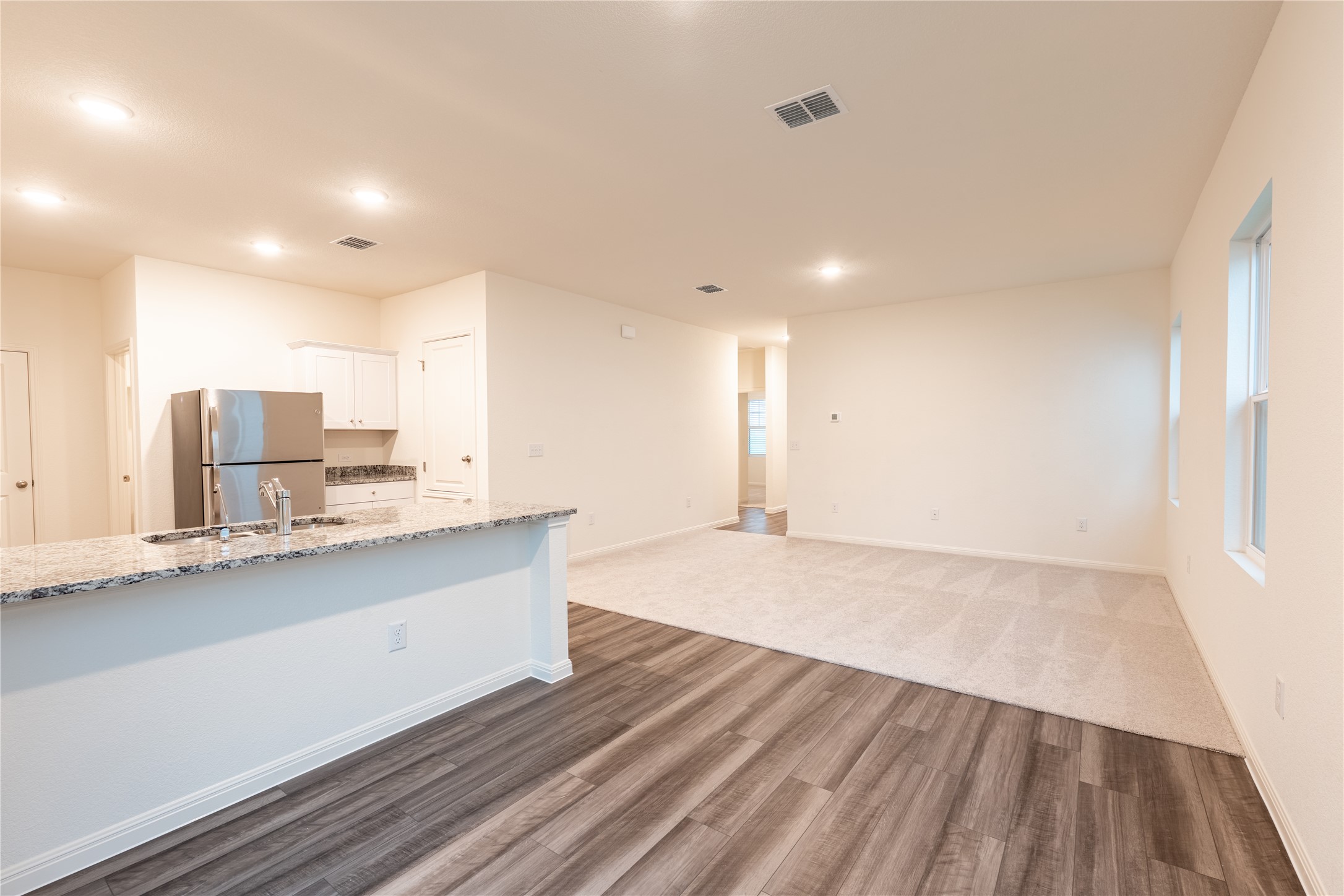 144 Mullen Way Taylor, TX 76574 - Photo 5 of 26 a view of kitchen with wooden floor and electronic appliances