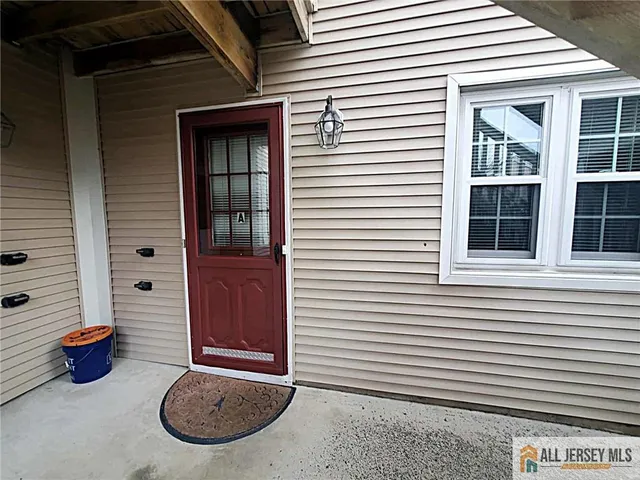 a view of a porch with a potted plant and a window