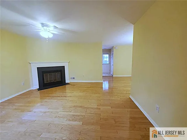 a view of empty room with a fireplace