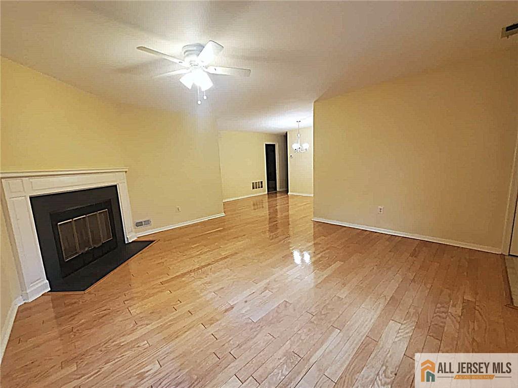 38 Rutland Lane, Unit 38A Monroe Township, NJ 08831 - Photo 5 of 19 a view of empty room with wooden floor and fan