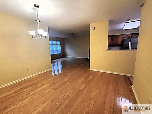 a view of a room with wooden floor and staircase