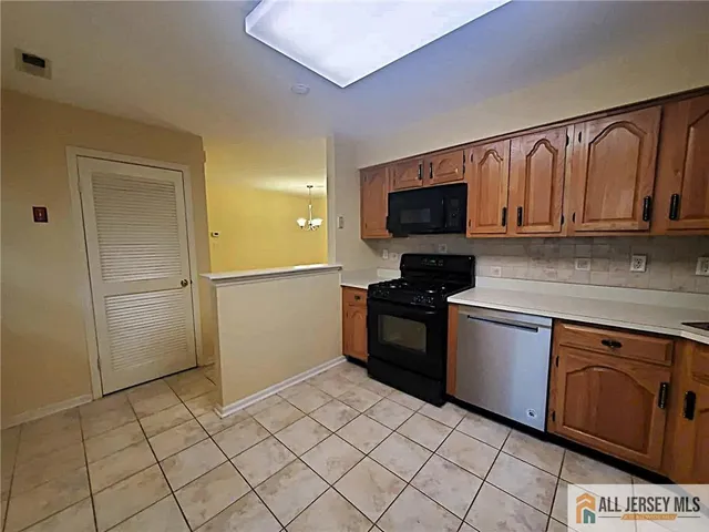 a kitchen with granite countertop a refrigerator and a sink