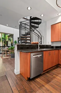 a kitchen with stainless steel appliances granite countertop a stove and wooden floor