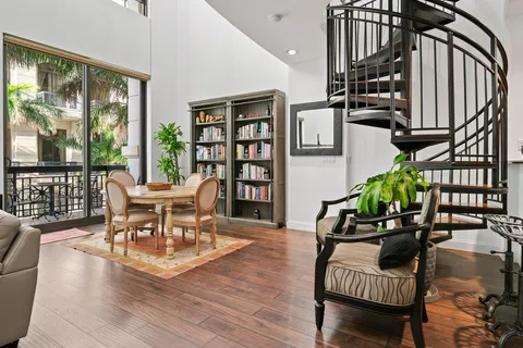 a dining room with furniture entryway and wooden floor