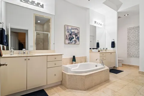 a bathroom with a tub sink and mirror