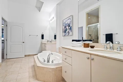 a bathroom with a bathtub sink and mirror