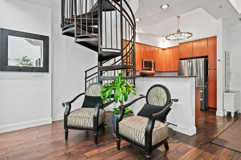 a living room with furniture a rug and a window