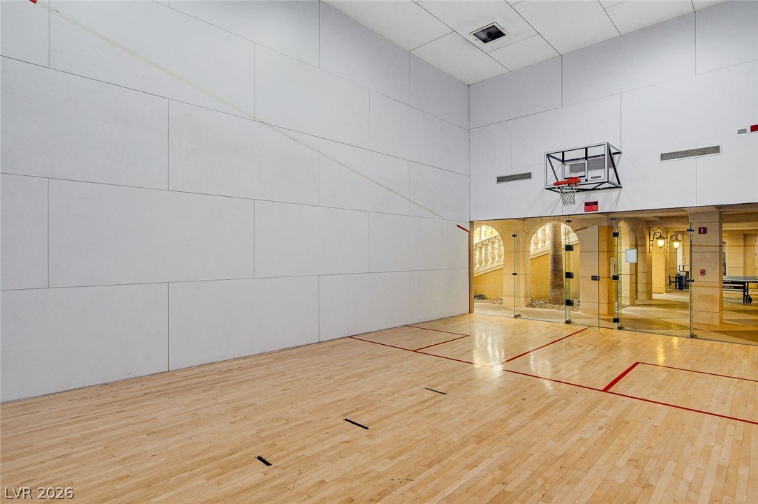 230 East Flamingo Road, Unit 106 Las Vegas, NV 89169 - Photo 53 of 66 An indoor sports court with pristine hardwood flooring and glass-paneled walls.