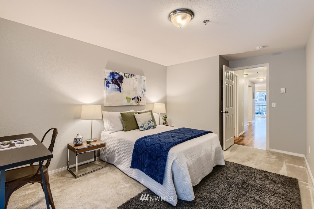 19410 Bothell Way Northeast, Unit D202 Bothell, WA 98011 - Photo 19 of 26 a bedroom with a bed and a chandelier