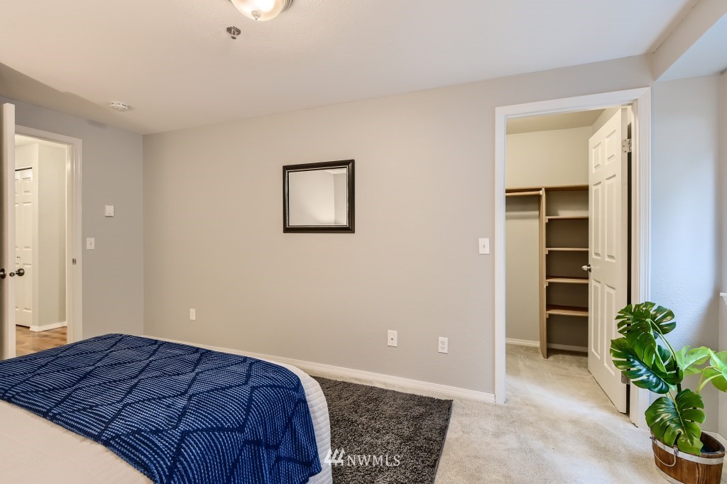 19410 Bothell Way Northeast, Unit D202 Bothell, WA 98011 - Photo 20 of 26 a bedroom with a bed and a potted plant