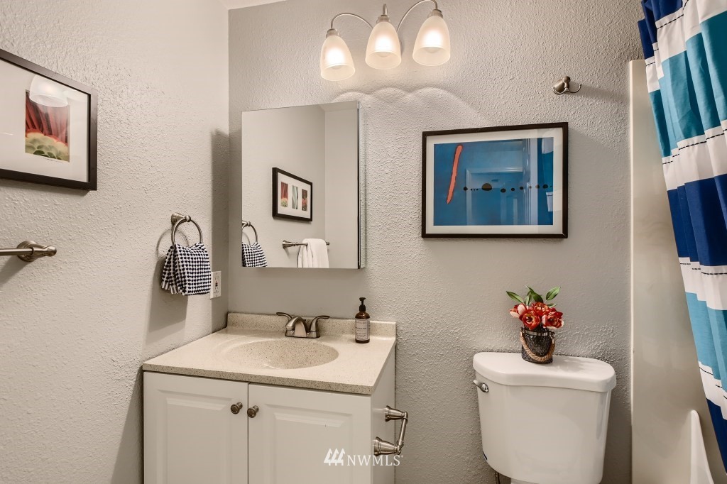 19410 Bothell Way Northeast, Unit D202 Bothell, WA 98011 - Photo 22 of 26 a bathroom with a toilet a sink and mirror