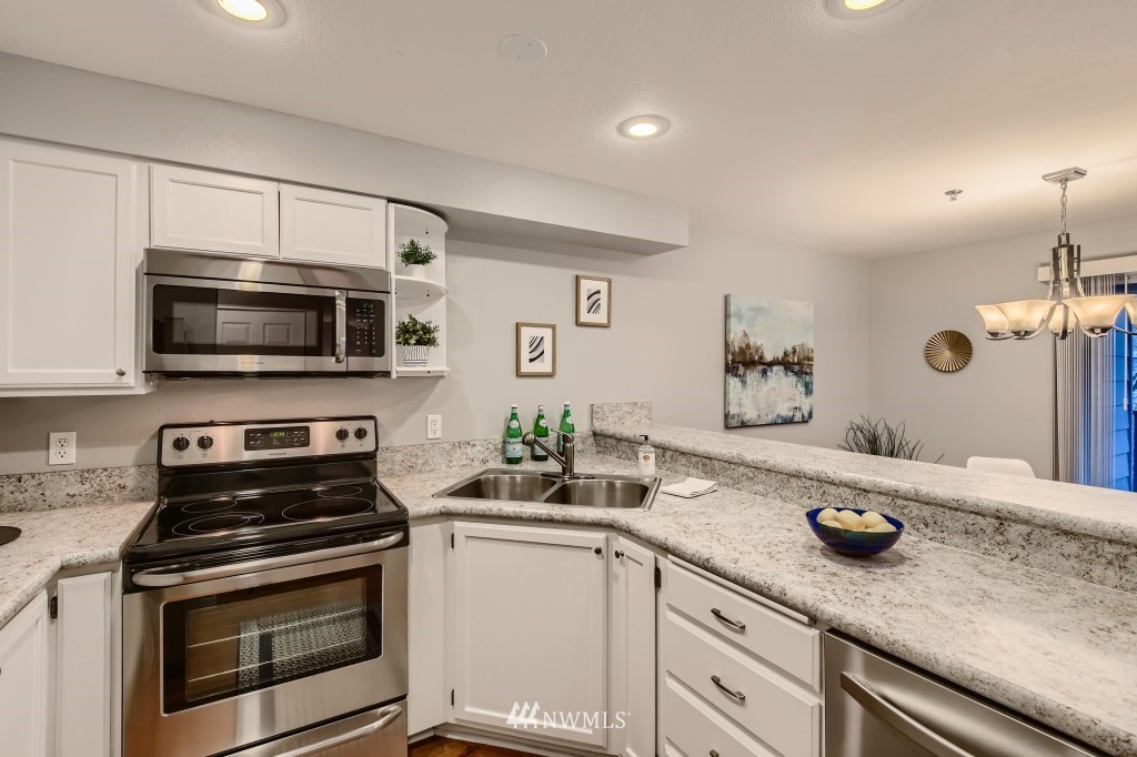 19410 Bothell Way Northeast, Unit D202 Bothell, WA 98011 - Photo 4 of 26 a kitchen with a sink and stainless steel appliances