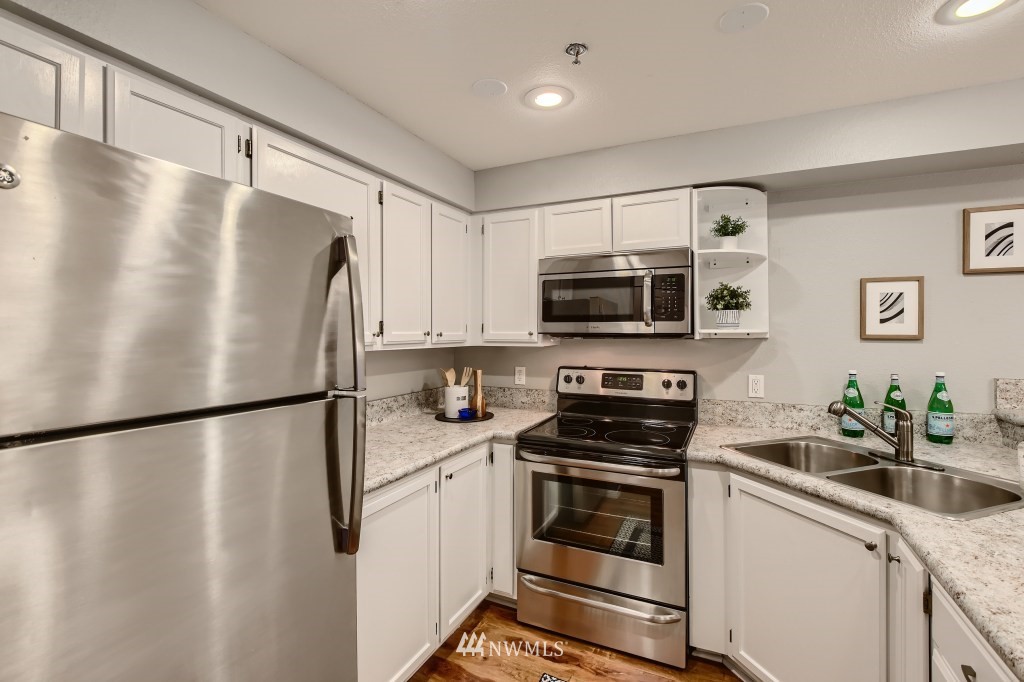 19410 Bothell Way Northeast, Unit D202 Bothell, WA 98011 - Photo 5 of 26 a white refrigerator freezer sitting in a kitchen