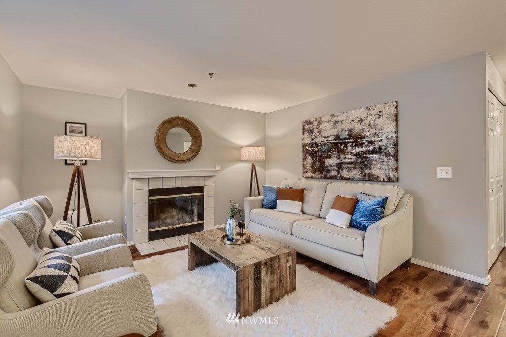 19410 Bothell Way Northeast, Unit D202 Bothell, WA 98011 - Photo 8 of 26 a living room with furniture a rug and a fireplace