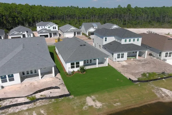 an aerial view of multiple houses with yard