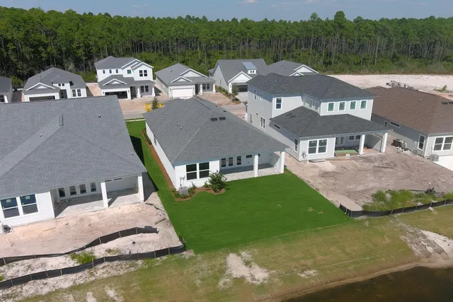 an aerial view of multiple houses with yard