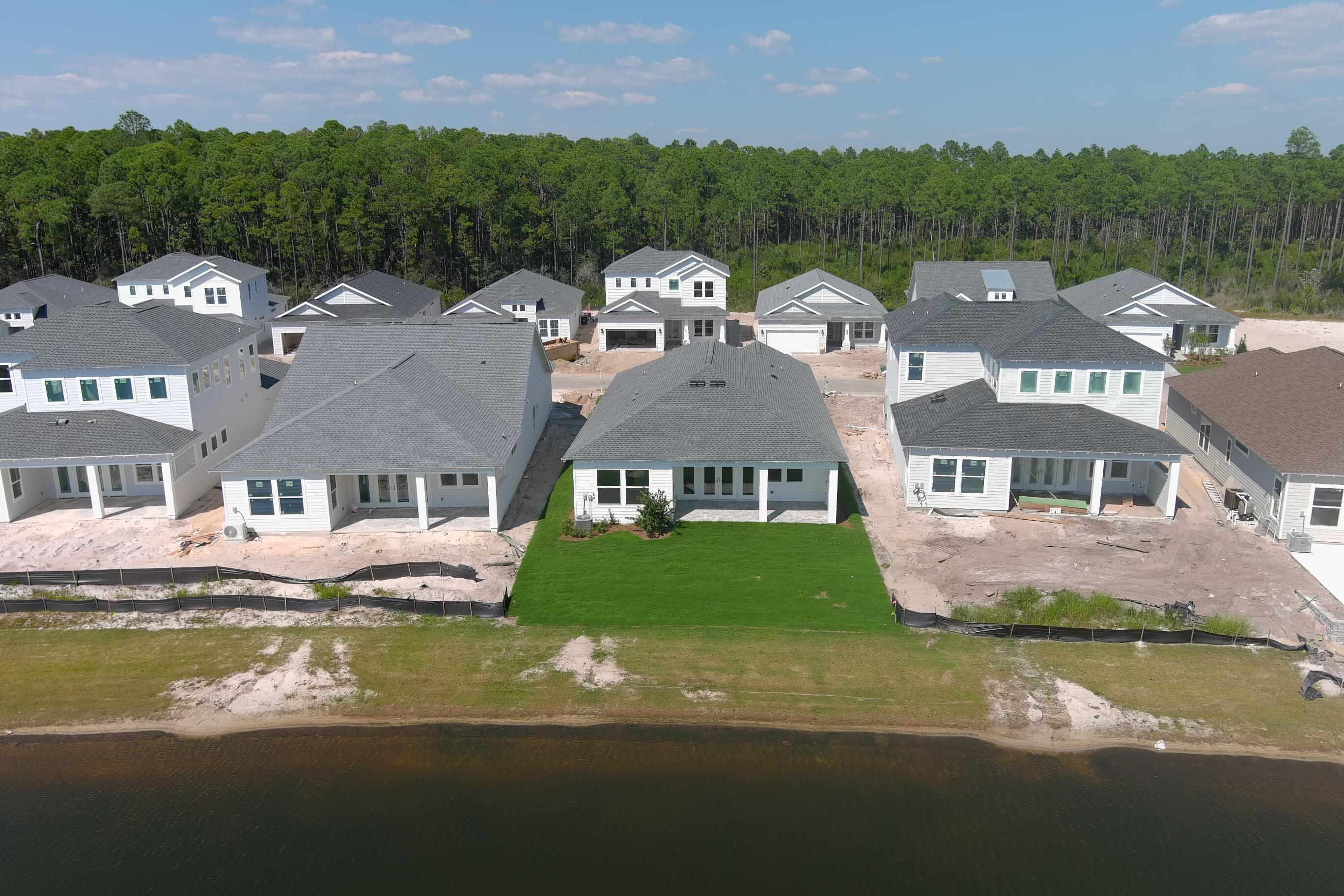 2332 Pathways Drive Watersound, FL 32461 - Photo 4 of 13 a front view of a house with a garden