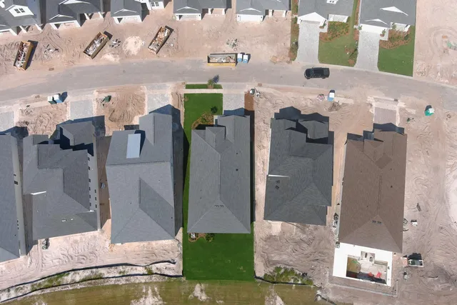 a bathroom with a granite countertop shower and a mirror