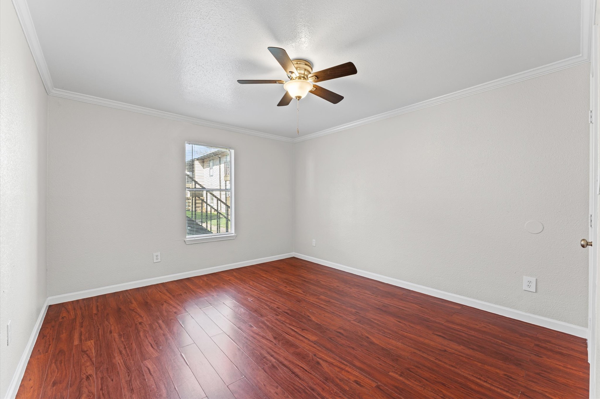 6161 Reims Road, Unit 802 Houston, TX 77036 - Photo 9 of 16 wooden floor in an empty room with a window