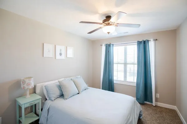 a bedroom with a large bed and a window