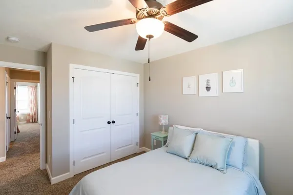 a bedroom with a bed and a chandelier