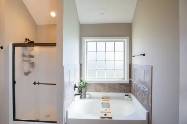 a bath tub sitting in a bathroom next to a sink