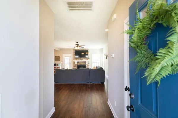a view of living room and kitchen with wooden floor