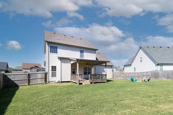 a view of a house with backyard and porch