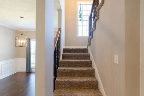 a view of staircase with white walls and windows