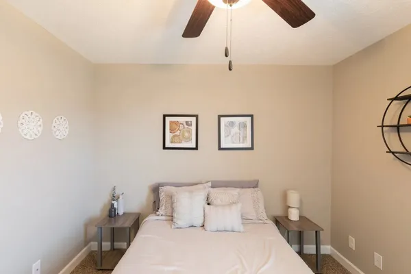 a bedroom with a bed and a chandelier