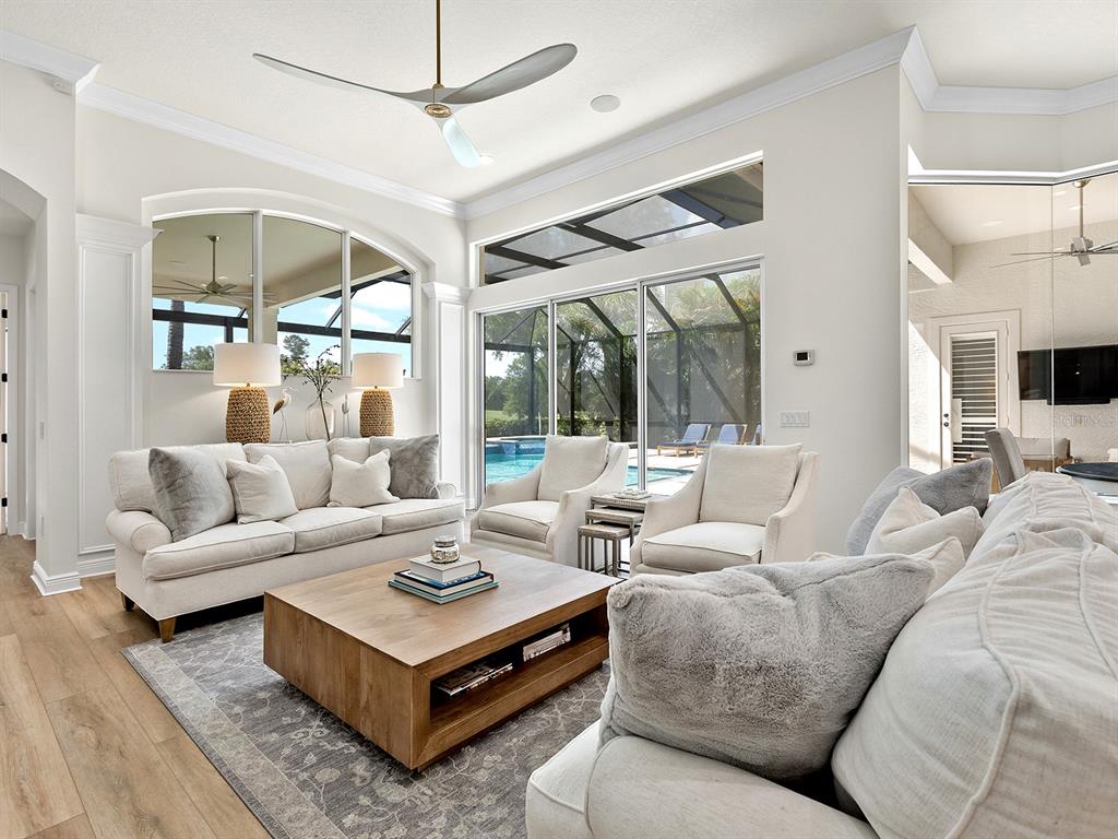 7431 Greystone Street Lakewood Ranch, FL 34202 - Photo 32 of 85 a living room with furniture a large window and a table