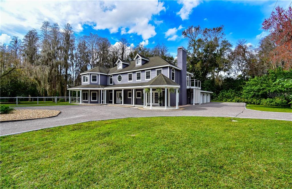 a view of a house with a yard porch and sitting area