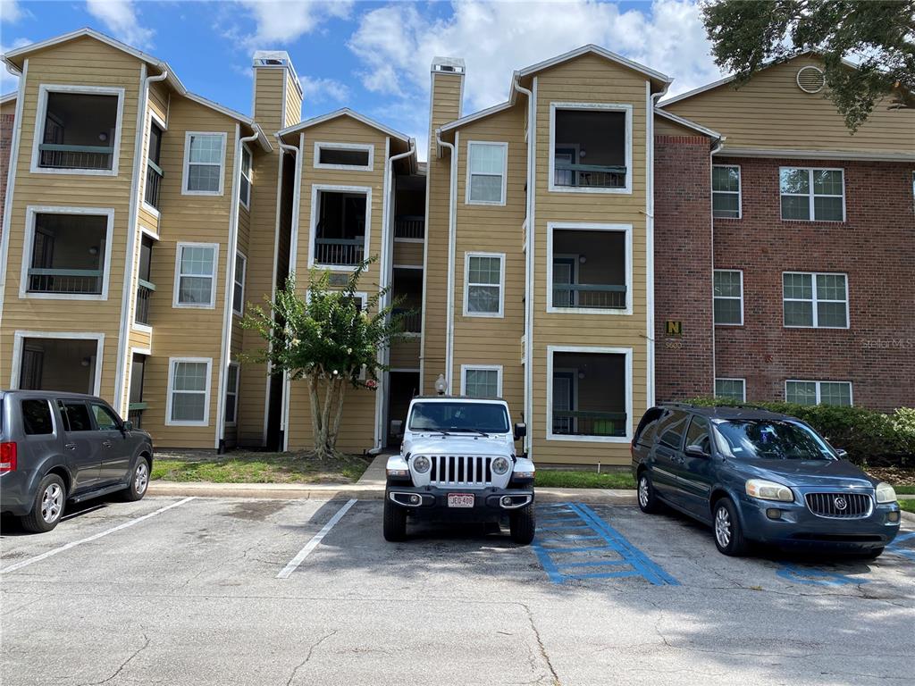5600 Devonbriar Way, Unit 206 Orlando, FL 32822 - Photo 1 of 1 a car parked in front of a brick house