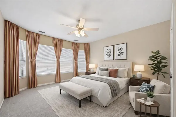 a bedroom with a large bed and a chandelier