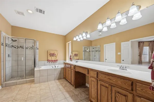 a spacious bathroom with a sink a large mirror and shower
