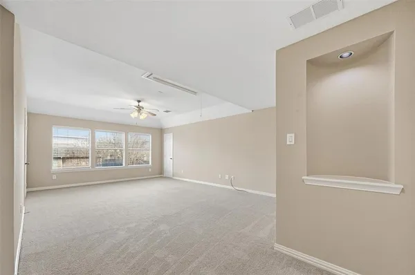 an empty room with windows and closet