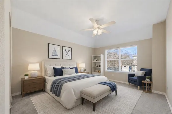 a bedroom with a bed and a large window