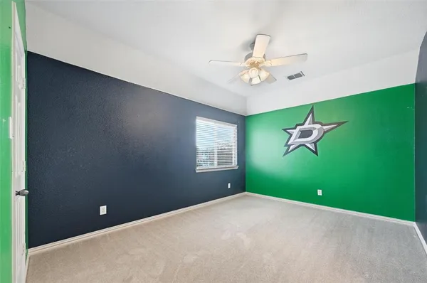 a view of a room with a ceiling fan and a window