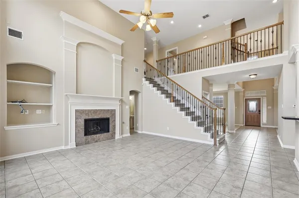 a view of entryway and hall with a fireplace