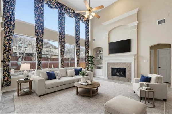 a living room with furniture a fireplace and a flat screen tv