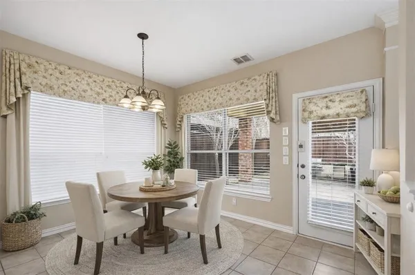 a dining room with furniture and window