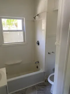 a bathroom with a bathtub and a toilet