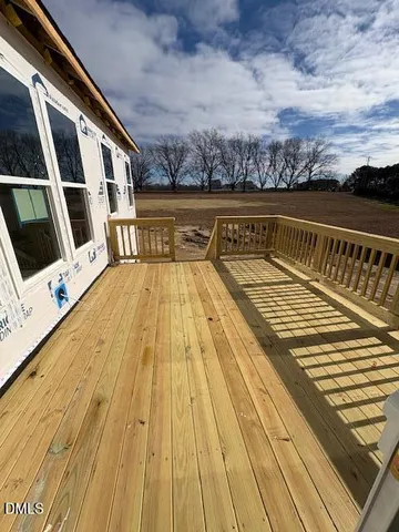 a view of balcony with wooden floor and city view