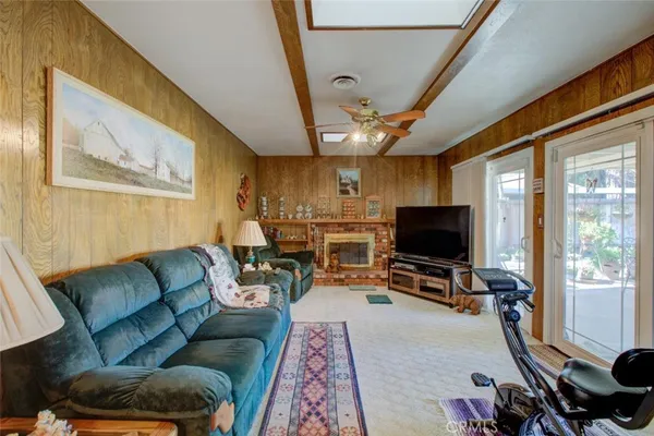 a living room with furniture a flat screen tv and a window